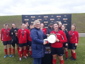 IT Sligo captain Rachel Kearns is presented with the trophy by Deirdre Hammond, the mother of the late Eithne Lydon who the Plate is named after.